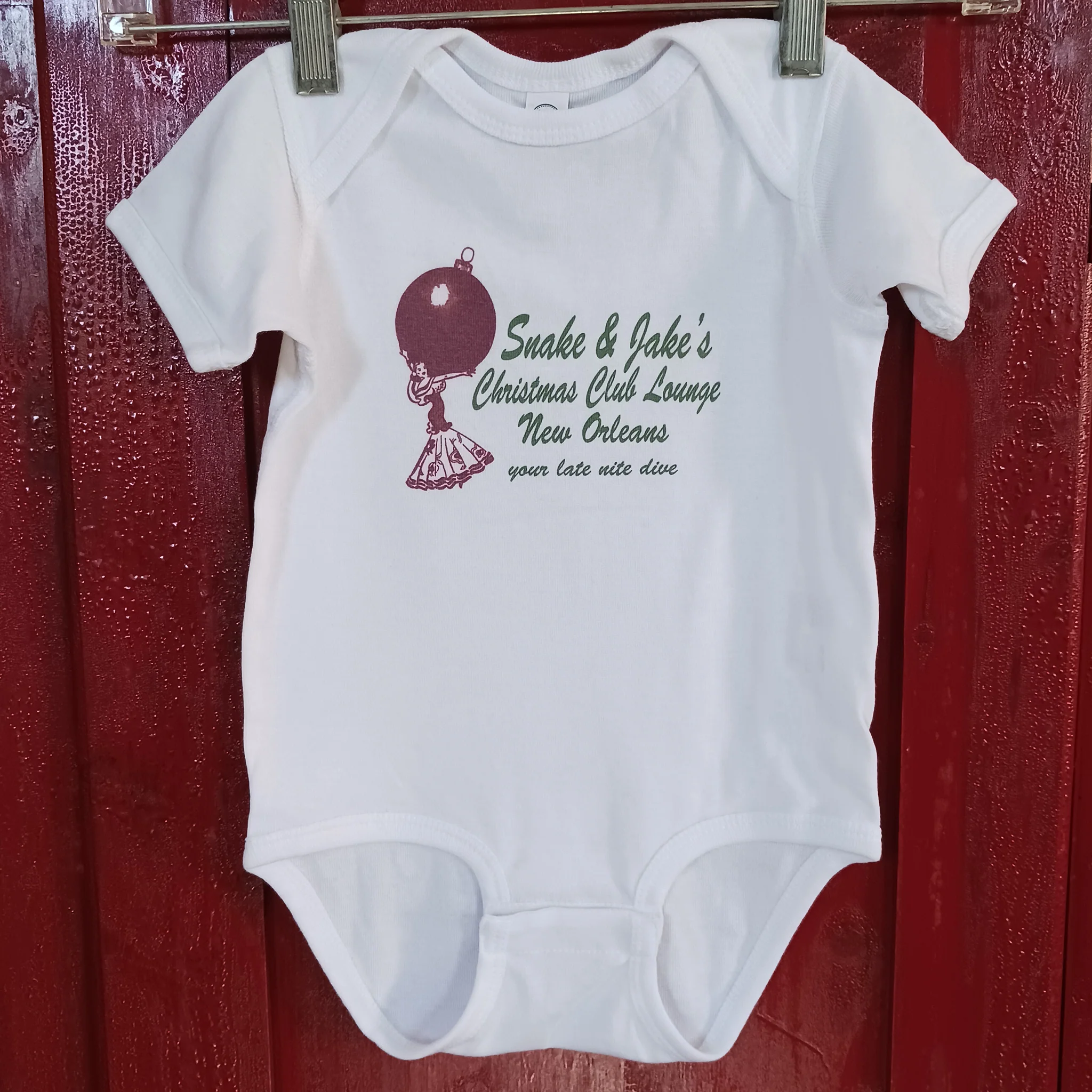 SNAKE & JAKE'S CHRISTMAS CLUB LOUNGE BABY SOFT ONESIE. 18MO.